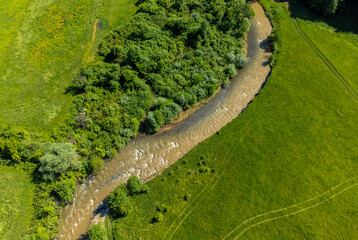 Aerial view of the Corund stream polluted with salt water from the Praid salt mine - Romania
