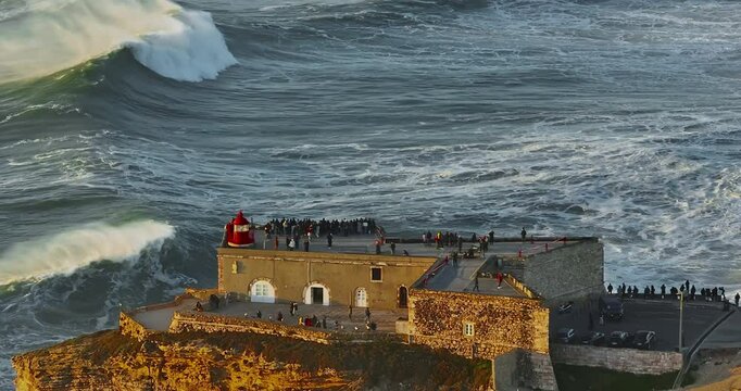 Aerial view of Nazare Lighthouse.The world's biggest waves crashing against the rocks of the stunning lighthouse. Portugal