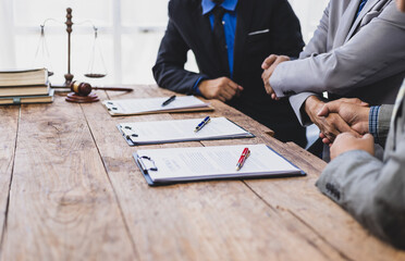 Businessman shaking hands after signing business cooperation and legal agreement contract.