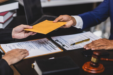 Lawyer receiving envelope with money for bribery. Corrupt lawyer receiving a bribe in an office, showcasing unethical behavior in law and finance. Hands accept money envelope.