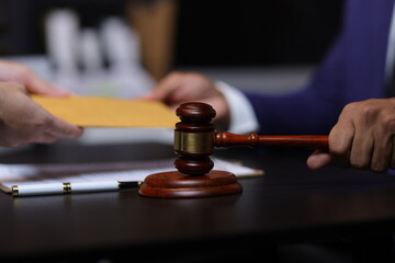 Lawyer receiving envelope with money for bribery. Corrupt lawyer receiving a bribe in an office, showcasing unethical behavior in law and finance. Hands accept money envelope.