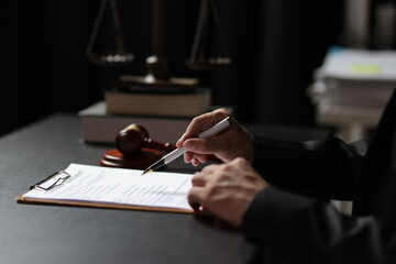 Lawyers are reading documents and writing, signing contract agreements.