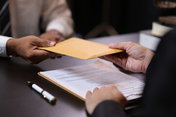 Lawyer receiving envelope with money for bribery. Corrupt lawyer receiving a bribe in an office, showcasing unethical behavior in law and finance. Hands accept money envelope.