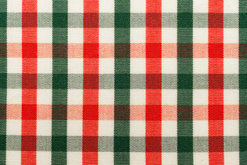 The texture of linen fabric in a large cage of green, red and white. Scottish tailoring material. Checkered fabric