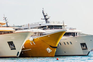 Line of many luxury smal cruise yacht boat ship docked Croatian bay harbor shore blue  clear water bright summer sunny sunset sunrise morning. Rich quality lifestyle. Boat vessel charter service