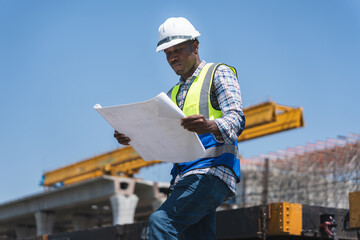 Engineer Man Inspecting During Bridge Construction Project, Construction worker on a construction site