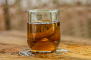 glass of tea on table with bokeh background