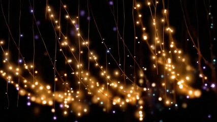 Strings of colorful LED fairy lights hang and glow softly against a dark background, creating a dreamy, magical atmosphere. Loopable holiday light - Powered by Adobe