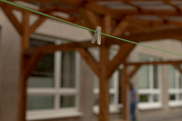 In this detailed closeup view, a clothespin can be seen affixed to a clothesline, picturesque...
