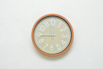 wall clock stuck to the white wall