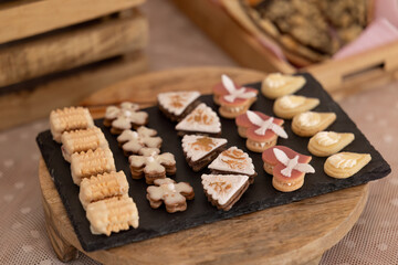 Christmas cookies with different shapes and icings lying on slate plate