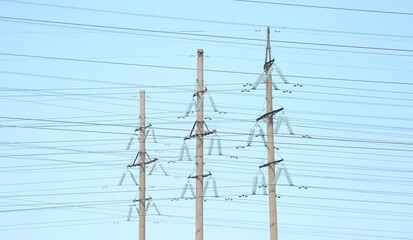 Three electric supports with power line wires