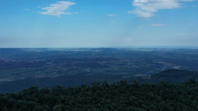 low motion drone view of Meugliano Lake bordered by dense conifer woods in Val di Chy, part of the Ivrea Morainic Amphitheatre, a prehistoric glacial landform in northern Piedmont, drone shot