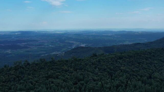 Aerial view of the Ivrea Morainic Amphitheatre, a vast glacial formation from the Pleistocene, with forests, farmland and villages near Ivrea, Italy, drone shot, slow motion