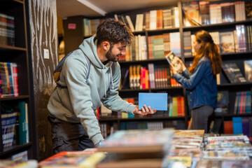 Male  Student Selecting Books in the Library