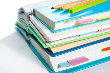 Notepad, notebooks, textbooks and books with bookmarks and stickers. The concept of diligent study