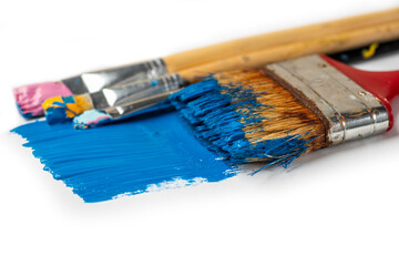 Old brushes with thick paints, acrylic or oil