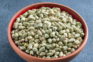 A bowlful of natural dried thyme seeds,closeup
