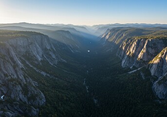 Valley view. Forest surrounds a vast gorge in a mountainous, sunny landscape