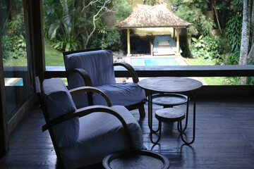 Two Cozy Wooden Armchairs with Coffee Table on Tropical Villa Terrace