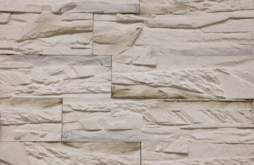 Textured stone wall featuring a natural, rustic design with warm tones and intricate patterns in a contemporary setting