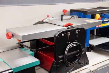 Woodworking machine for precise cuts in a workshop environment located indoors during daylight hours