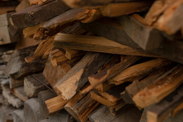 A detailed closeup view showcasing neatly arranged stacks of firewood, ideal for utilization in heating spaces or for various cooking purposes, ensuring warmth and meals during cold times