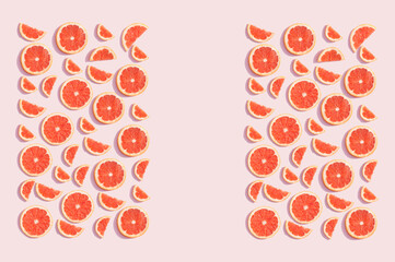 Summer grapefruit with large empty space on a pink background. Fruit concept.