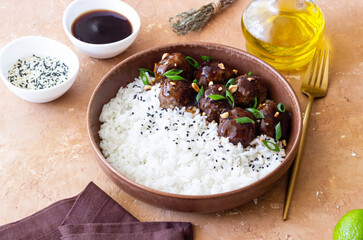 Beef meatballs in teriyaki sauce with rice. Asian food.