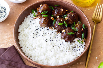Beef meatballs in teriyaki sauce with rice. Asian food.