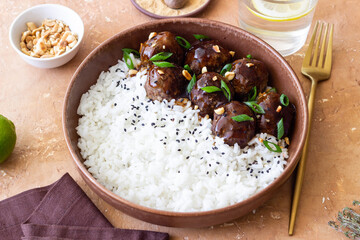 Beef meatballs in teriyaki sauce with rice. Asian food.