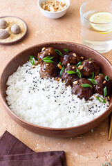 Beef meatballs in teriyaki sauce with rice. Asian food.