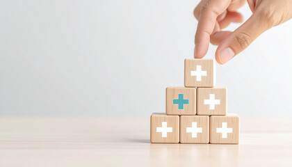 Hand stacking wooden healthcare symbol blocks on table, showing medical concept, wellness, and support in calm, hopeful atmosphere