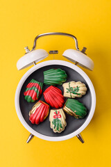 Christmas, gingerbread or madeleine on a plate on a vintage clock. Christmas conceptual background