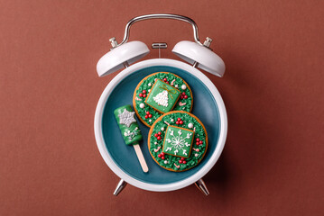 Christmas, eclair on a plate on a vintage clock. Christmas time conceptual background