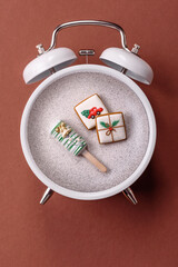 Christmas, eclair on a plate on a vintage clock. Christmas time conceptual background