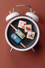 Christmas, eclair on a plate on a vintage clock. Christmas time conceptual background