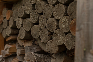 The image portrays a meticulously arranged and neatly stacked pile of firewood logs, showcasing...
