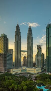 Time lapse of the skyline of Kuala Lumpur City Center in Malaysia at sunset. Vertical Video.