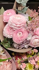 Soft pink ranunculus flowers arranged in a delicate bouquet with eucalyptus and pastel blooms. Concept of romance, tenderness and celebration of beauty in nature