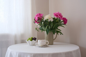 A Beautiful and Elegant Table Setting Featuring Fresh Flowers and Tea for a Perfect Gathering