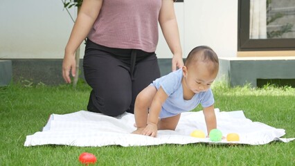 At home, a baby plays with their parents and aunt, sharing moments of laughter and occasional tears. The lively atmosphere reflects the warmth, joy, and emotional ups and downs of family life.
