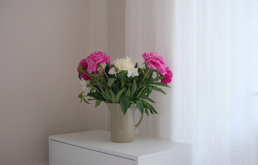 An Elegant Bedroom Corner Bathed in Soft Lighting Surrounded by Fresh Flowers and Beauty