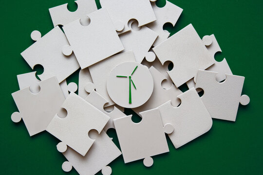 Puzzle pieces with wind turbine symbol in center on green background. Wind energy solution concept perfect for renewable energy and sustainability presentations. Wind turbine concept