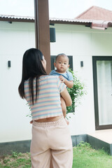 At home, a baby plays with their parents and aunt, sharing moments of laughter and occasional tears. The lively atmosphere reflects the warmth, joy, and emotional ups and downs of family life.

