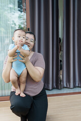 At home, a baby plays with their parents and aunt, sharing moments of laughter and occasional tears. The lively atmosphere reflects the warmth, joy, and emotional ups and downs of family life.
