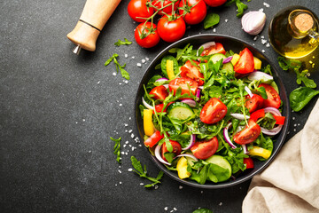 Salad with leaves, tomatoes, pepper and olive oil.