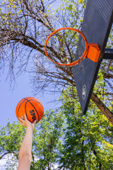 Basketball player shooting the ball towards the hoop