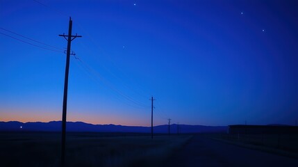 Obraz premium Glowing power lines against a deep blue sky, abstract energy infrastructure with dramatic contrast lighting, symbolizing modern urban vitality.