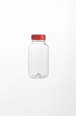 A plastic bottle with a red cap on a white background.
